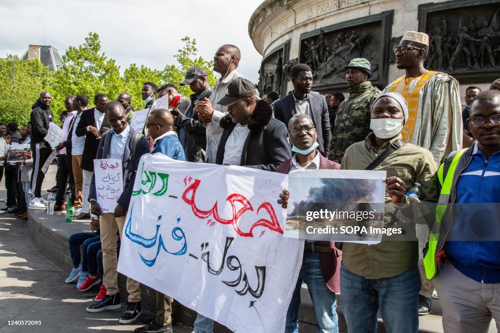 Male protesters hold a placard expressing their opinion...