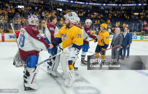 Connor Ingram of the Nashville Predators skates hands with Pavel Francouz of the Colorado Avalanche after a 5-3 loss in Game Four of the First Round...