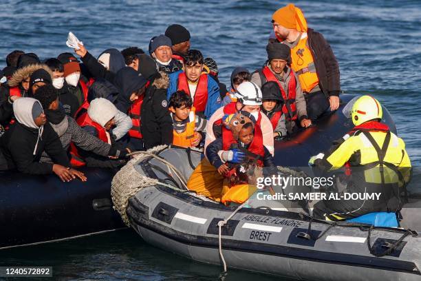 Migrants are rescued by crew members of the Abeille Languedoc ship after their boat's generator broke down in French waters while they were trying to...