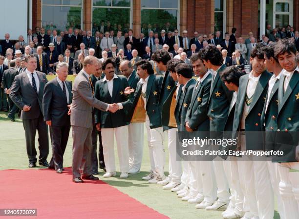 Prince Phillip is introduced to Saleem Malik of Pakistan and the rest of the team by captain Javed Miandad during the lunch interval on day three of...