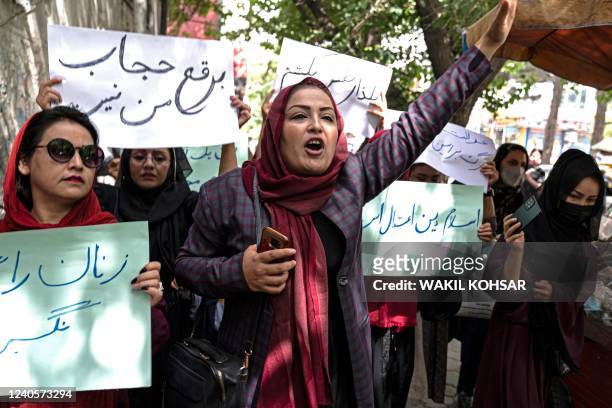 Members of Afghanistan's Powerful Women Movement, take part in a protest in Kabul on May 10, 2022. - About a dozen women chanting "burqa is not my...