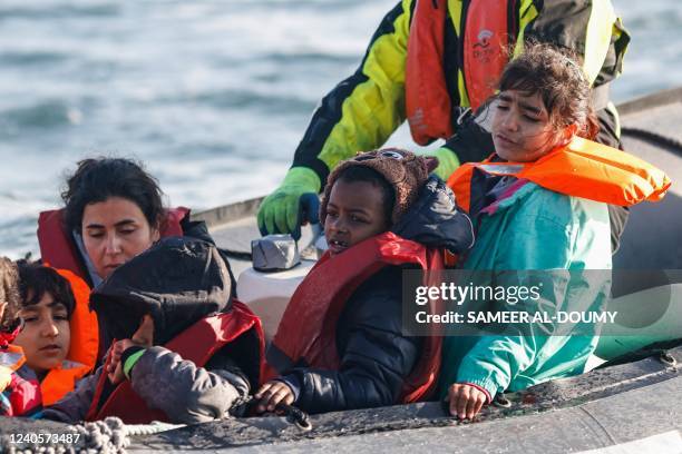 Migrants are rescued by crew members of the Abeille Languedoc ship after their boat's generator broke down in French waters while they were trying to...