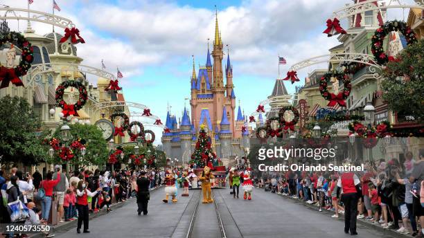 Crowds line Main Street USA, with Cinderella Castle on the horizon, at the Magic Kingdom at Walt Disney World, in Lake Buena Vista, Fla. Monday, Dec....