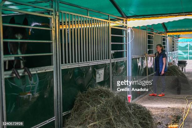 Larysa, age 32 gives water to an evacuated horse in a temporary evacuation stable in Lviv, Ukraine on May 09, 2022. One month after the start of...