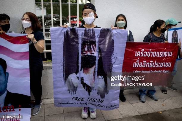 Protesters hold banners during a demonstration calling for the release of prisoners charged under article 112, Thailand's lese majeste royal...