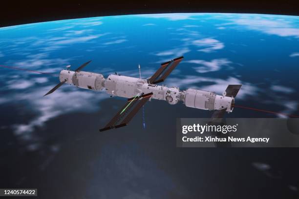 This simulated image captured at Beijing Aerospace Control Center on May 10, 2022 shows China's cargo spacecraft Tianzhou-4 docking with the...