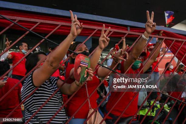 Supporters of Philippine presidential candidate Ferdinand Marcos Jr celebrate outside his campaign headquarters after his landslide presidential...