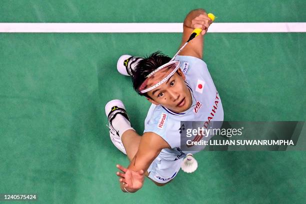 Japan's Kento Momota returns a shot against England's Toby Penty during their men's singles group stage match at the 2022 Thomas and Uber Cup...