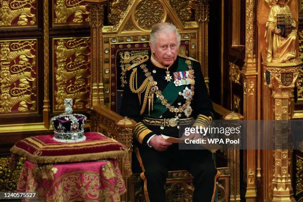 Prince Charles, Prince of Wales reads the Queen's speech next to her Imperial State Crown in the House of Lords Chamber, during the State Opening of...