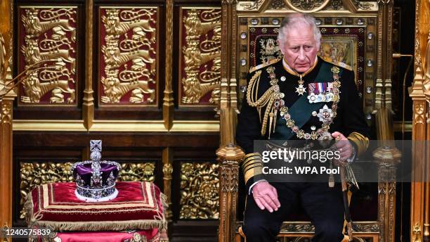 Prince Charles, Prince of Wales sits by the The Imperial State Crown in the House of Lords Chamber, during the State Opening of Parliament in the...