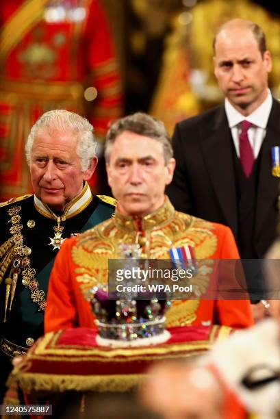 Prince Charles, Prince of Wales and Prince William proceed behind the Imperial State Crown through the Royal Gallery for the State Opening of...