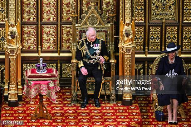 Britain's Prince Charles, Prince of Wales and Britain's Camilla, Duchess of Cornwall sit by the The Imperial State Crown in the House of Lords...