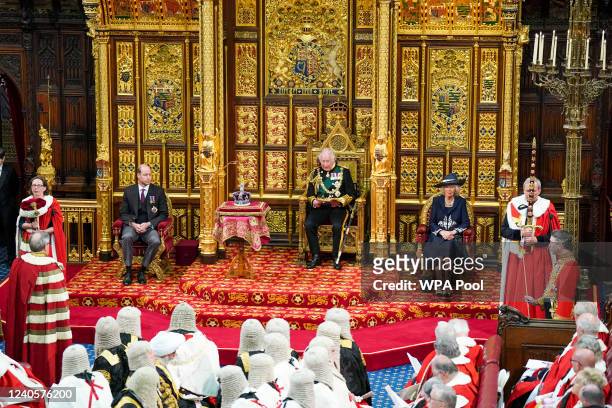 Prince Charles, Prince of Wales reads the Queens Speech as Prince William and Camilla, Duchess of Cornwall sit next to him during the State Opening...
