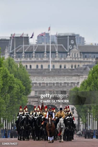 Members of the Household Cavalry ride down The Mall as they return to barracks in London, on May 10, 2022 after attending the State Opening of...