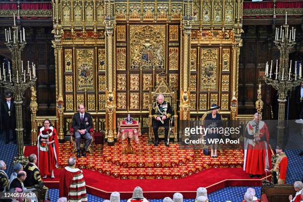 Britain's Prince Charles, Prince of Wales reads the Queen's Speech as he sits by the Imperial State Crown , Britain's Camilla, Duchess of Cornwall...