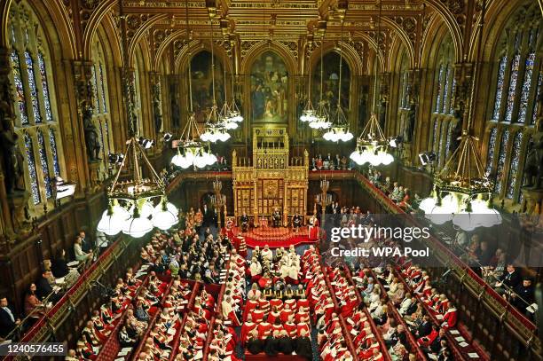 Britain's Prince Charles, Prince of Wales reads the Queen's Speech as he sits by the Imperial State Crown , Britain's Camilla, Duchess of Cornwall...