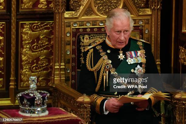 Prince Charles, Prince of Wales reads the Queen's speech next to her Imperial State Crown in the House of Lords Chamber, during the State Opening of...