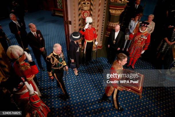Prince Charles, Prince of Wales, Camilla, Duchess of Cornwall and Prince William proceed behind the Imperial State Crown through the Royal Gallery...
