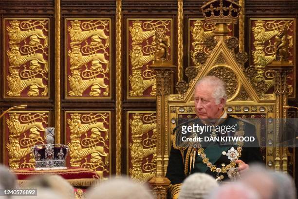 Britain's Prince Charles, Prince of Wales looks towards the Imperial State Crown as he delivers the Queen's Speech in the House of Lords Chamber...