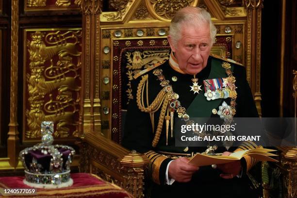 Britain's Prince Charles, Prince of Wales reads the Queen's Speech as he sits by the Imperial State Crown, in the House of Lords chamber, during the...