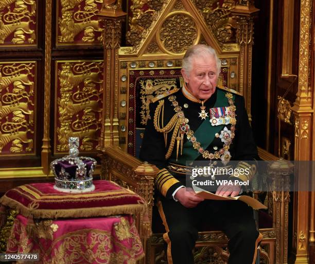 Prince Charles, Prince of Wales reads the Queen's speech next to her Imperial State Crown in the House of Lords Chamber, during the State Opening of...