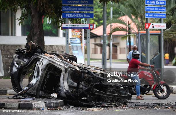 The burned buses near Sri Lanka's former prime minister Mahinda Rajapaksa's official residence, a day after they were torched by protesters in...