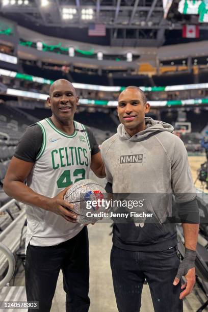 Al Horford of the Boston Celtics poses for a photo with the NBA 75 diamond ball and his father, Tito Horford after Game 4 of the Eastern Conference...