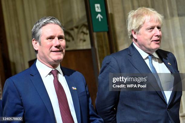 Britain's Prime Minister Boris Johnson and Britain's main opposition Labour Party leader Keir Starmer walk through the Central Lobby at the Palace of...