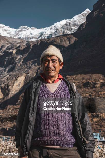 Local man as seen under the Langtang Lirung peak. Langtang Lirung peak as seen from Langtang village, part of the Langtang Himal mountain in Nepal...