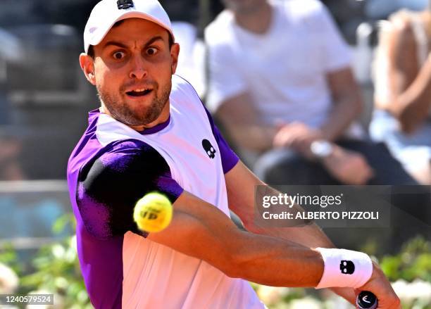 Russia's Aslan Karatsev returns to Serbia's Novak Djokovic during their first round match at the ATP Rome Open tennis tournament on May 10, 2022 at...