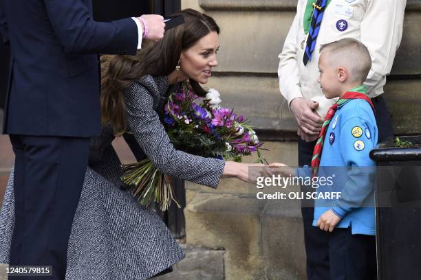 Britain's Catherine, Duchess of Cambridge speaks with scout Archie Mc Williams, aged 7, as she departs Manchester Cathedral after attending the...