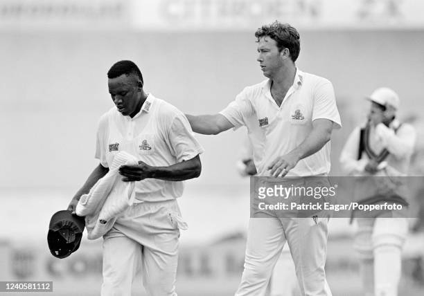 Devon Malcolm of England gets encouragement from teammate Derek Pringle after bowling an over on day three of the 5th Test match between England and...
