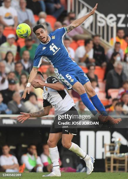 Real Betis' Spanish defender Marc Bartra vies with Valencia's Spanish forward Hugo Duro during the Spanish league football match between Valencia CF...