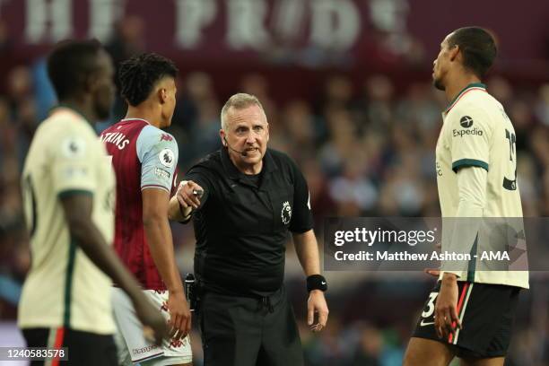Match referee Jonathan Moss in discussion with Joel Matip of Liverpool during the Premier League match between Aston Villa and Liverpool at Villa...