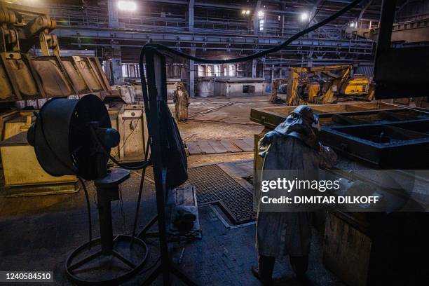 Steel workers work on the maintenance of the blast furnace at Zaporizhstal, Ukraine's third-biggest metals plan, in Zaporizhzhia on May 10 amid the...