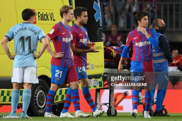 Barcelona's Uruguayan defender Ronald Araujo, on a stretcher, is evacuated by ambulance after an injury, during the Spanish league football match...