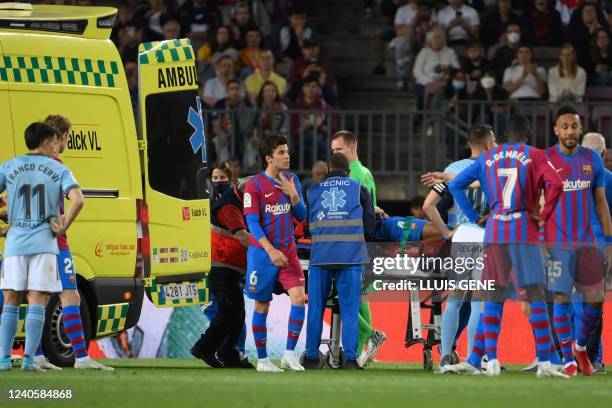 Barcelona's Uruguayan defender Ronald Araujo, on a stretcher, is evacuated by ambulance after an injury, during the Spanish league football match...