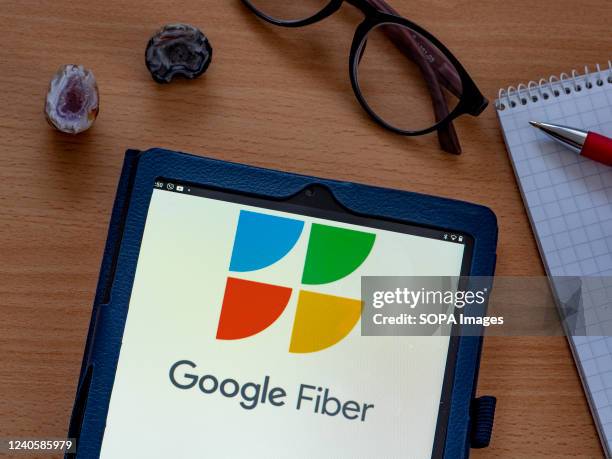 In this photo illustration Google Fiber Inc. Owned by Alphabet Inc. Logo seen displayed on a tablet.