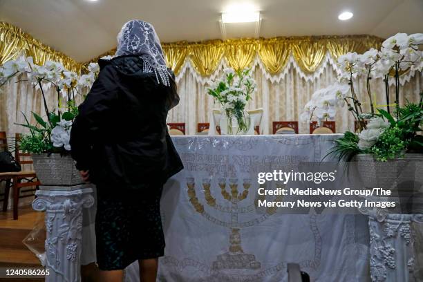 Parishioner puts money into a donation box at the Iglesia Evangelica Apostoles y Profetas church in San Jose, Calif., on Sunday, May 8, 2022. The...