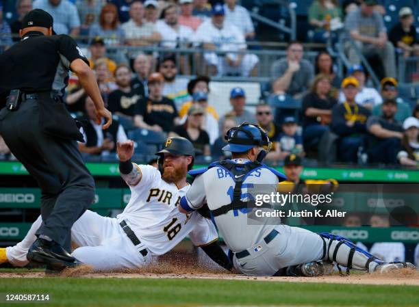 Austin Barnes of the Los Angeles Dodgers tags out Ben Gamel of the Pittsburgh Pirates in the first inning in the third inning during the game at PNC...