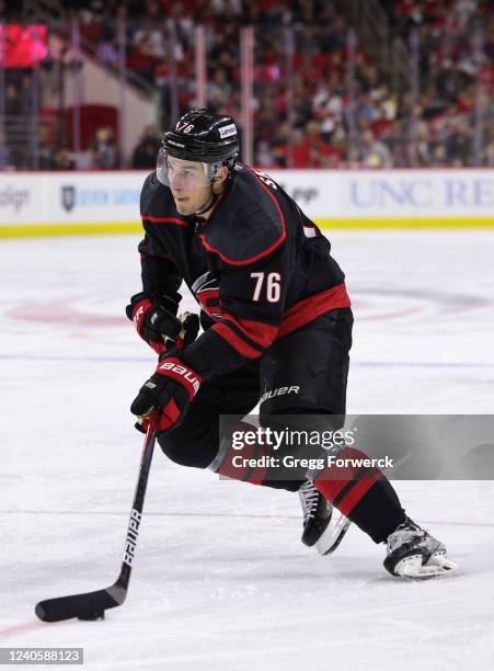 Brady Skjei of the Carolina Hurricanes skates with the puck in Game Five of the First Round of the 2022 Stanley Cup Playoffs on against the Boston...