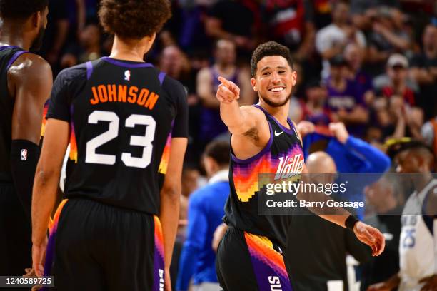 Cameron Johnson of the Phoenix Suns talks with Devin Booker during Game 5 of the 2022 NBA Playoffs Western Conference Semifinals on May 10, 2022 at...