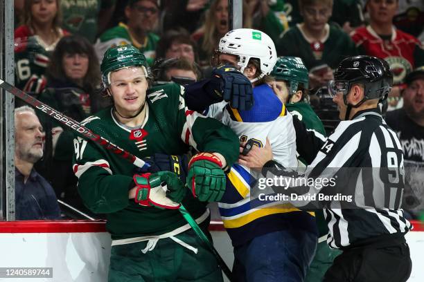 Linesman Bryan Pancich breaks up a scrum between Kirill Kaprizov of the Minnesota Wild and Robert Thomas of the St. Louis Blues in the second period...