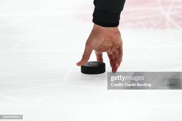 Linesman Bryan Pancich picks up the puck for the face off between the St. Louis Blues and Minnesota Wild in the first period in Game Five of the...