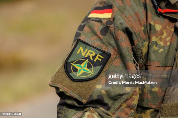The NATO Response Force batch is seen on the uniform of a Bundeswehr, the German armed forces, soldier during the Wettiner Heide international joint...