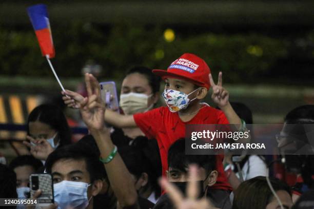 Supporters of Philippine presidential candidate Ferdinand Marcos Jr celebrate outside his campaign headquarters after his landslide presidential...