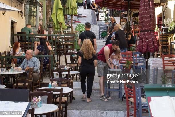 Tourists enjoy their coffee on a cafe in Plaka district in Athens, Greece on May 11, 2022.