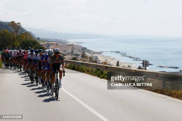 The pack rides along Sicilia's northeastern coastline during the 5th stage of the Giro d'Italia 2022 cycling race, 174 kilometers between Catania and...