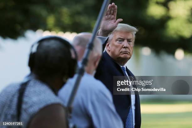President Donald Trump waves to journalists as he returns to the White House after posing for photographs in front of St. John's Episcopal Church...