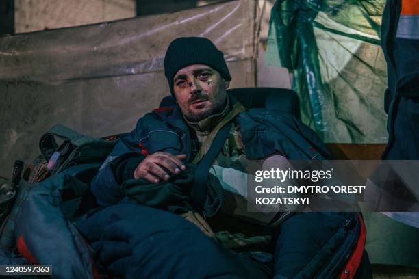 This photo released on May 10, 2022 by the Azov regiment shows an injured Ukrainian serviceman inside the Azovstal iron and steel works factory in...